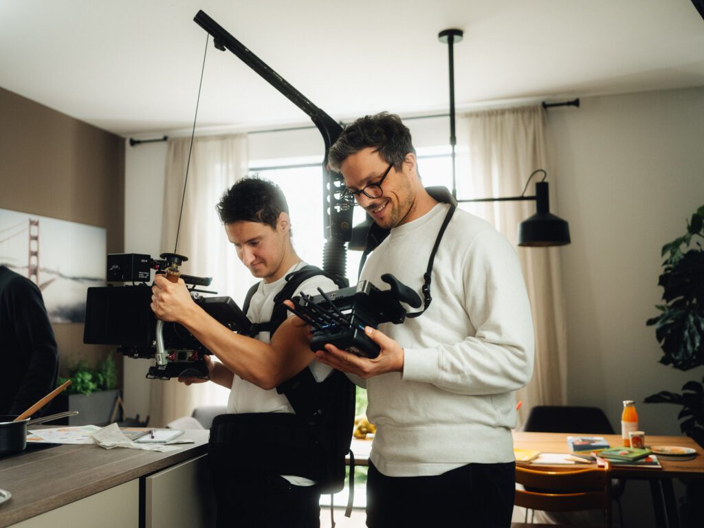 Christian Martin Schäfer checking the image on the wireless monitor next to the camera operator