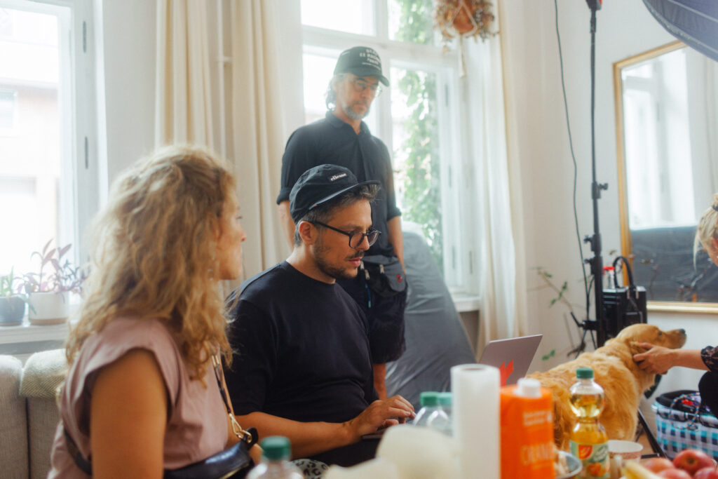 Christian Martin Schäfer at the laptop during the 8in1 cinema ad shoot, the canine lead on the right