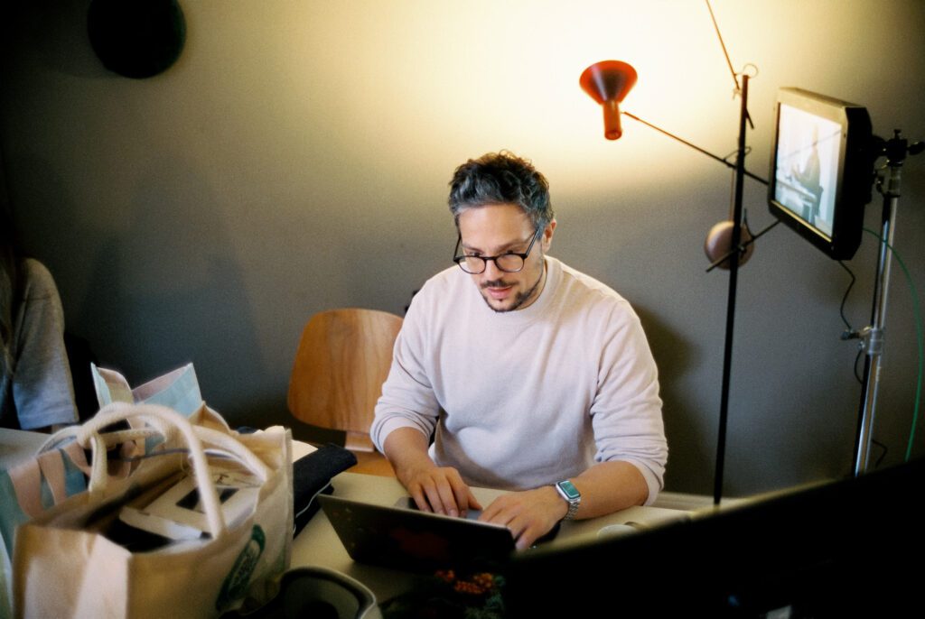 Christian Martin Schäfer working on a laptop on set
