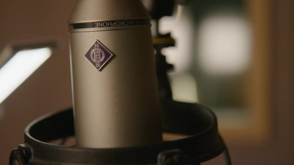 Close-up of a high-quality Neumann studio microphone in its shock mount