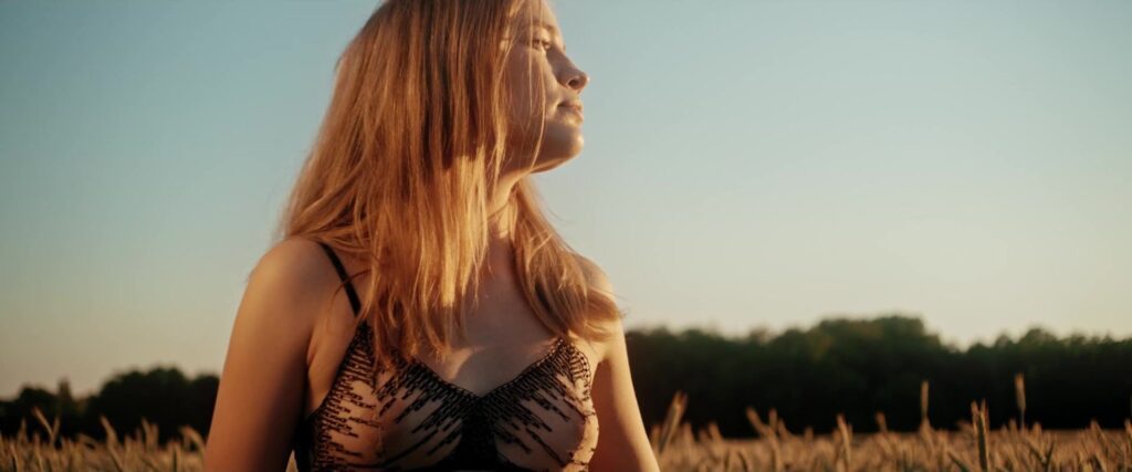 Profile portrait of a woman in black lace lingerie in the warm sunset