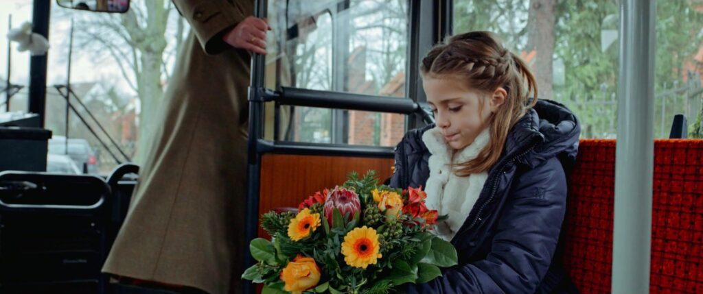 Girl receives a colourful bouquet of flowers as a loving gesture