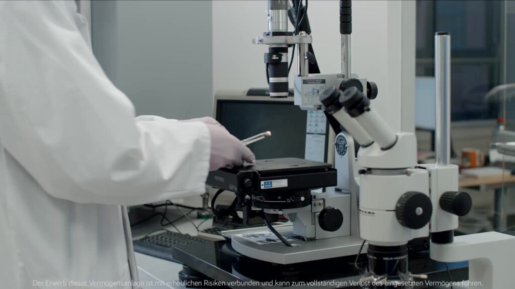 Female technician examines an implant under the measuring microscope in the laboratory