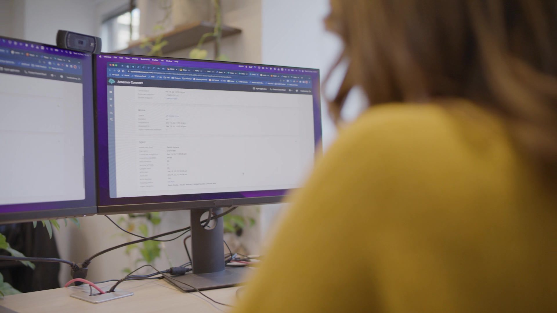 Female employee works at the screen with the Amazon Connect dashboard