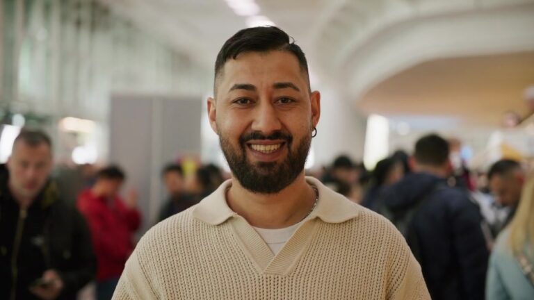 Portrait of a smiling visitor in the packed hall