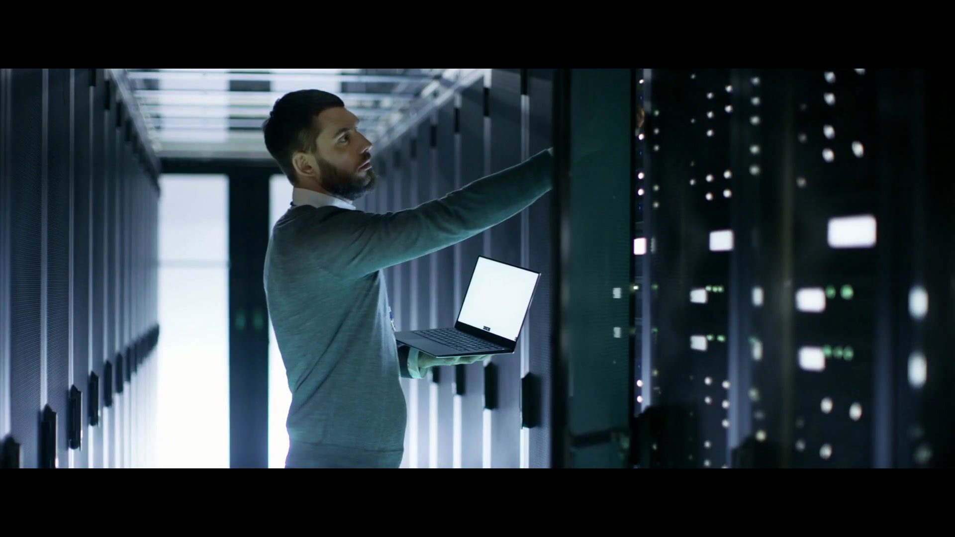 Technician with a laptop checks servers in a modern data center