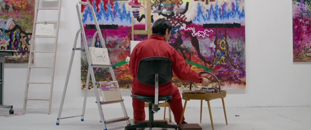 Ryo Kato malt an einem großformatigen Gemälde in seinem Atelier