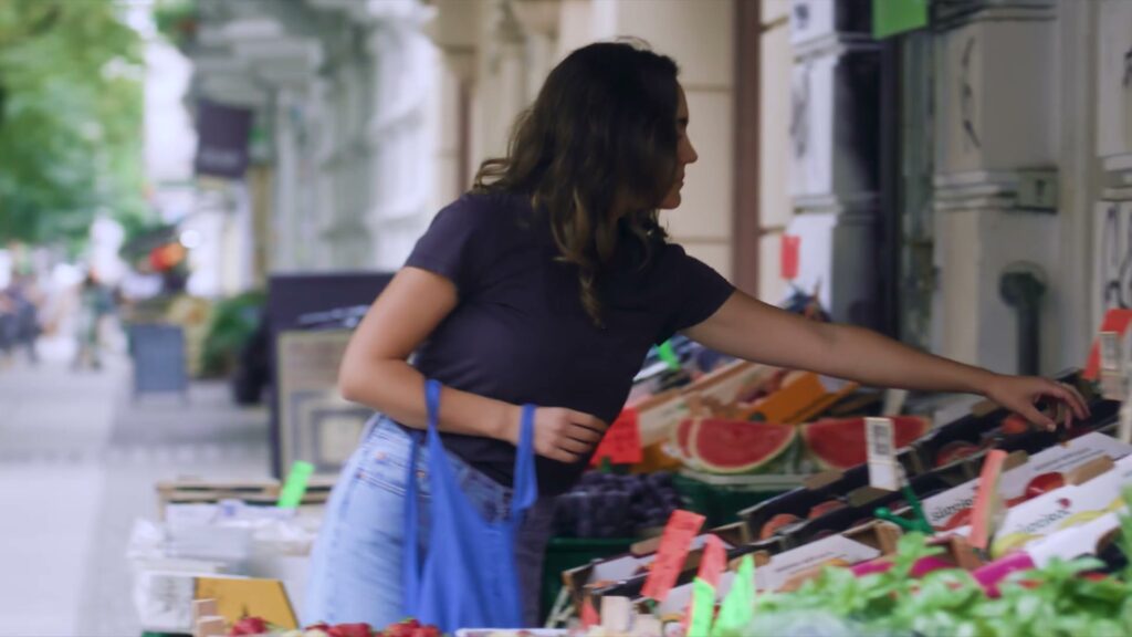 Shopping at a Berlin market stall, a scene from the Airbnb film *Connection in Times of Crisis*