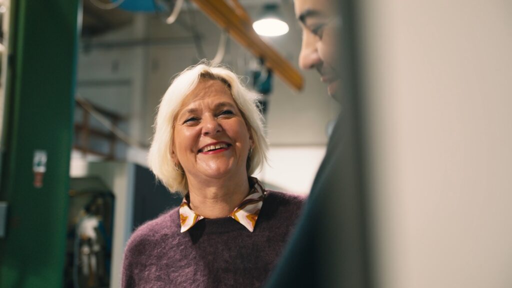 Heike Hilmer-Börner, managing director of Hilmer GmbH CNC-Technik, laughs in the factory in Hanover