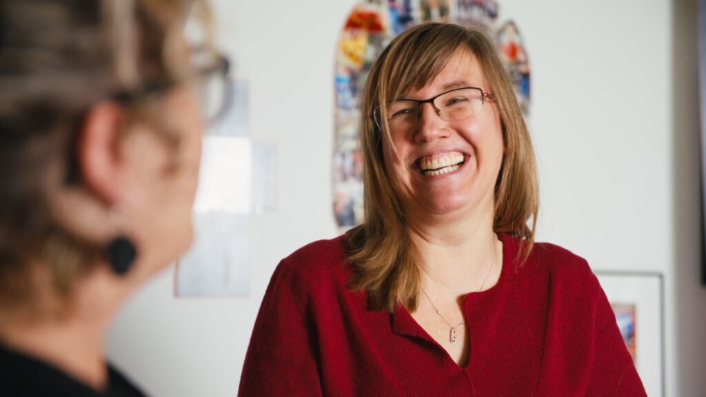 Julia Michaux-Stander of IBB Institut für Berufliche Bildung laughs during a conversation